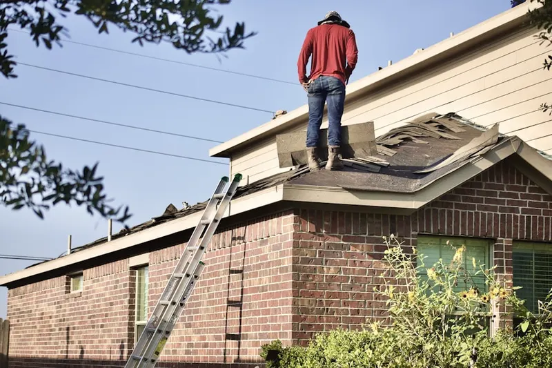 Professional roofer working on a residential roof in Wheaton